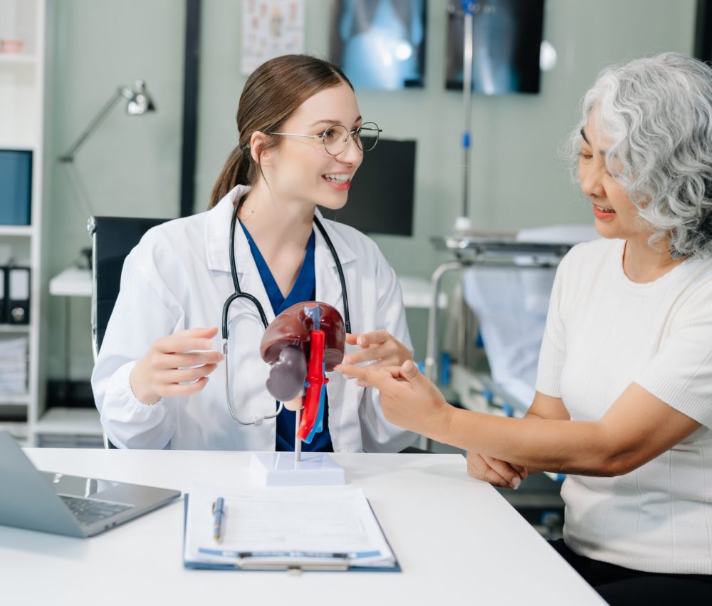 Doctor in white suit take notes while discussing and Asian elderly, man patient who lying on bed with receiving saline solution in hospital or clinic.